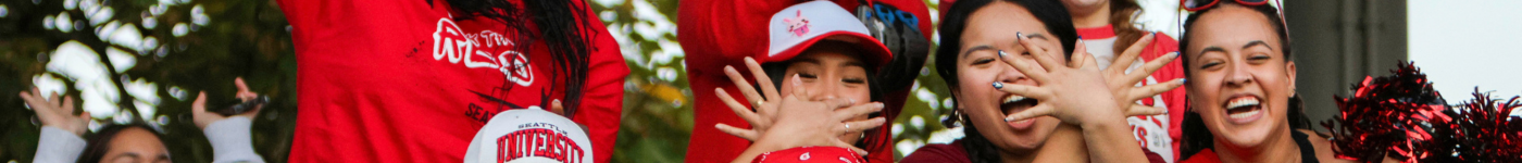 Seattle University students flash "the hawk" hand signal.